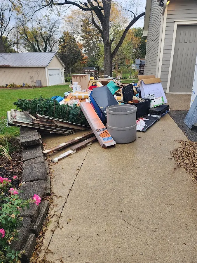 Dumpster being loaded with debris for 12 Yard Dumpster Rental in Independence